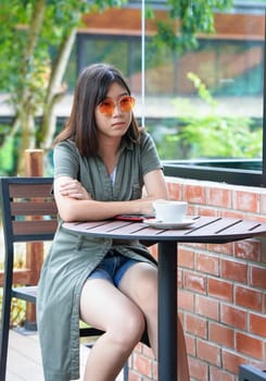 Pretty woman sitting in a cafe terrace with coffee cup