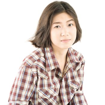 Young pretty woman in plaid shirt posing in studio with isolated on white background