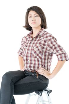 Young pretty woman in plaid shirt posing in studio with isolated on white background