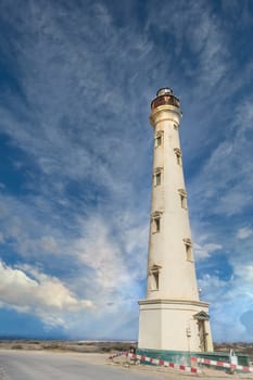 An old white brick lighthouse under nice sky in Aruba
