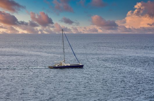 Blue and White Sailboat Alone in Caribbean Sea