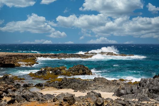 Black volcanic rock on shore of Aruba