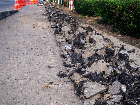 the Road repairing works with jackhammer. machine drills asphalt