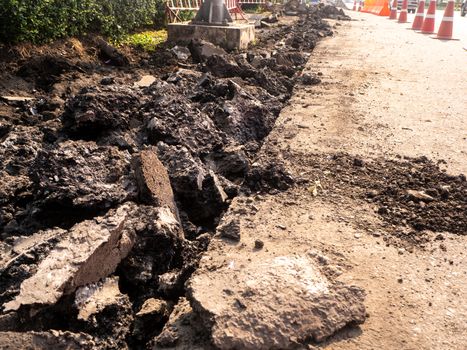 the Road repairing works with jackhammer. machine drills asphalt
