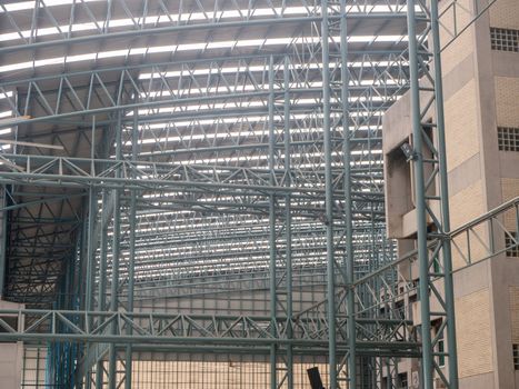 Big warehouse steel plate roof ceiling structure, with iron beams, perspective background, as shadow reflection from glass tile wall