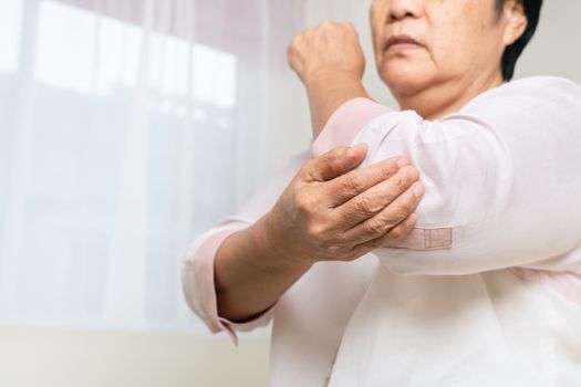 elbow pain old woman suffering from elbow pain at home, healthcare problem of senior concept