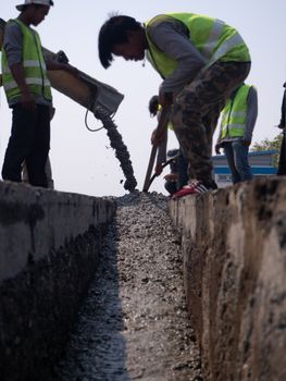 The Builders pouring cement during Upgrade to residential street.