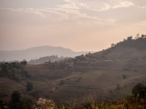 Mountain valley village farm fields landscape.