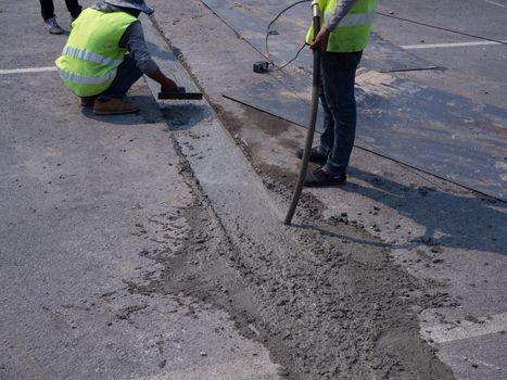 The Builders pouring cement during Upgrade to residential street.