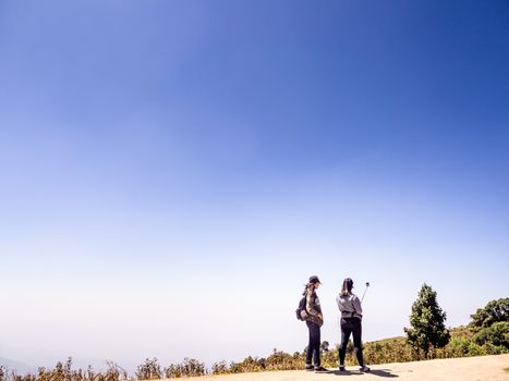 Tourist on the peak of high rocks. Sport and active life concept