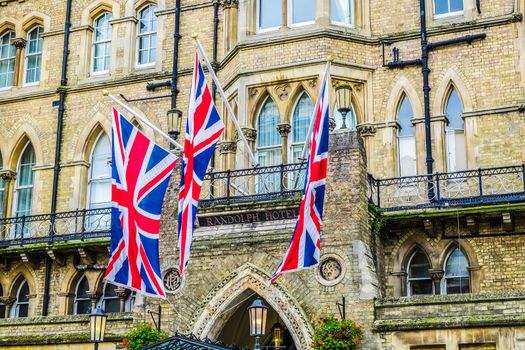 England Oxford Sept 27th 2016 Facade with flags of Macdonald Randolph Hotel built in Victorian Gothic style.