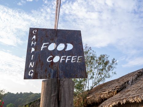 wooden label hanging at wooden pole