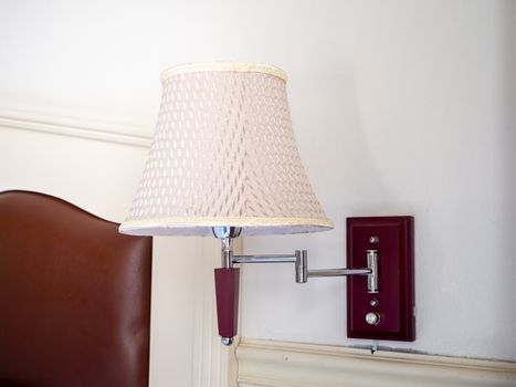 bedroom interior with pillows and reading lamp on bedside table