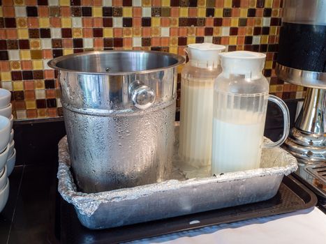 Fruit juice dispensers and coffee & tea water on a self service breakfast counter in a hotel.