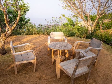 table and chairs standing on a lawn at the garden