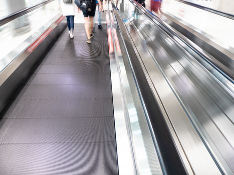 The skywalk with blurred business people in airport