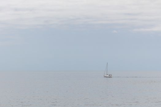 A white boat sailing through a calm sea in the Atlantic ocean