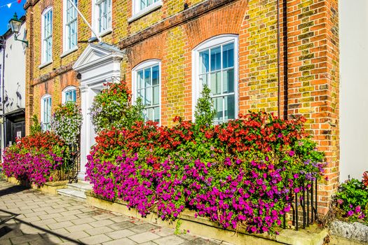 England Henley on Thames Sept 27 2016 red brick house with beautiful hanging baskets and window box