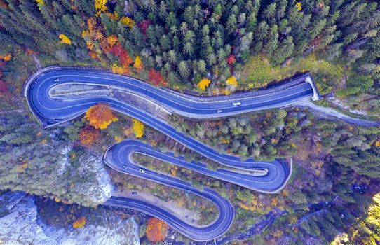 Above view of a curvy road through autumn forest in a canyon. Bicaz gorge is a narrow pass between two historical Romanian region.