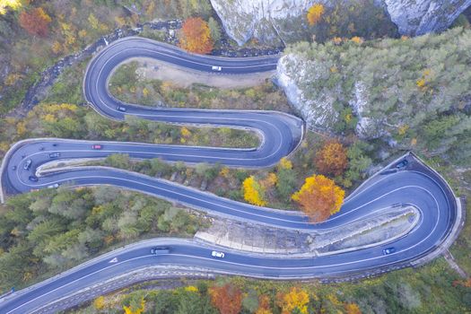 Drone view of a curvy mountain road, autumn scene . Bicaz gorge is a narrow pass between two historical Romanian region.