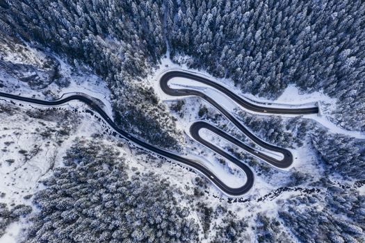 Winter serpentine in rocky mountain forest. Bicaz gorge is a narrow pass between two historical Romanian region.