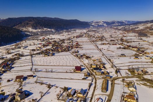 Aerial winter landscape of a traditional romanian village, Moldovita village in Moldavia