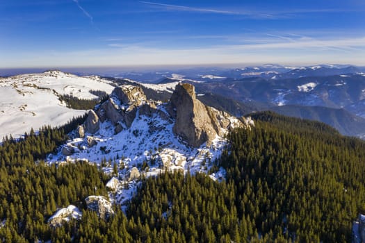 Rocky mountain landscape, Lady's Stones in Rarau mountains, aerial winter panorama of Rarau top.
