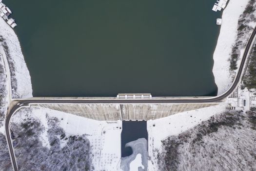 Water barriere dam viewed from above, dam and road on it in the winter. Bicaz Dam in Romanian Carpathians.