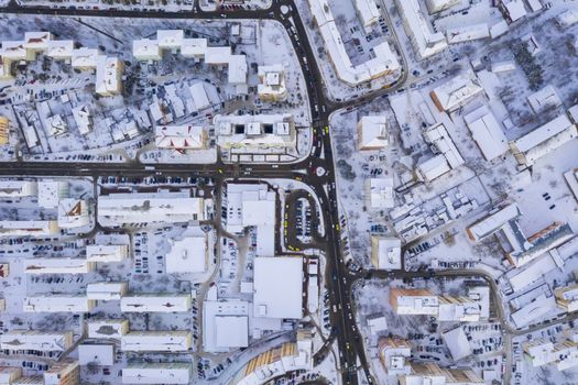 Above view of traffic on city streets intersection, winter scene in Piatra Neamt, Romania