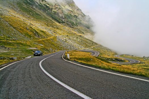 Curvy Transfagarasan road in a foggy day. Summer morning in Fagaras mountains.