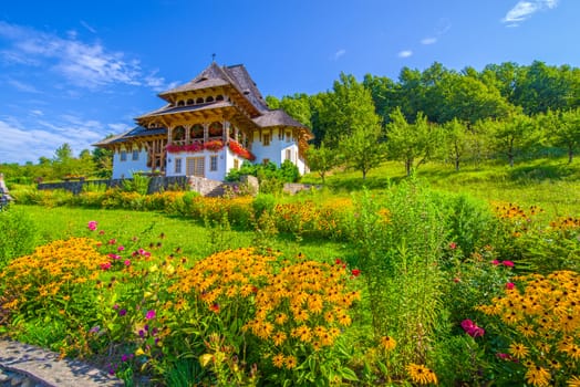 Beautiful flower garden at Barsana Monastery in Maramures region, summer scene