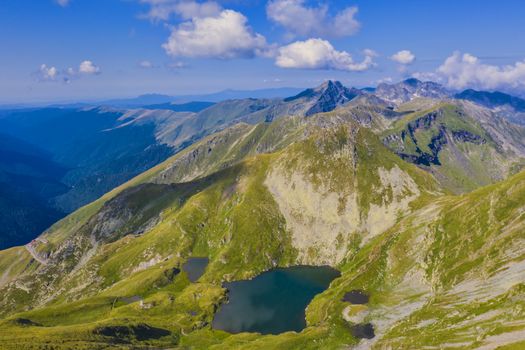 Summer landscape with Capra glacier lake and Fagaras mountain crest, Romanian Carpathians.