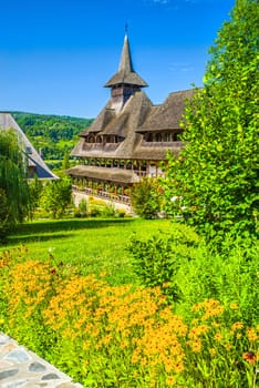 Summer landscape at Barsana monastery in Romania. House in the middle of nature.