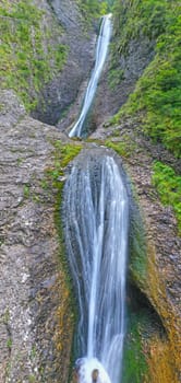 Water stream on rock wall, Duruitoarea waterfall in Romania