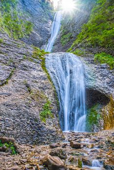 Mountain stream and rocky waterfall, Duruitoarea waterfall in Romanian Carpathians.