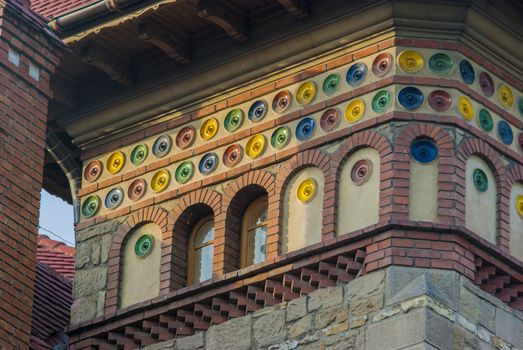 Architecture details of old building, colored ceramic dishes