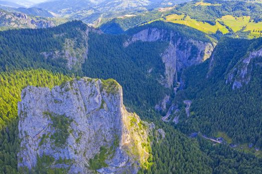 Rocky mountain pass in Romanian Carpathians, road on valley.