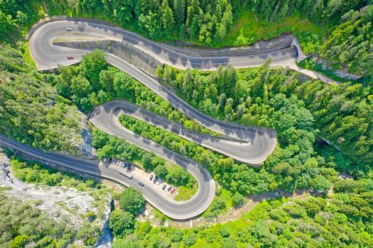 Above view of winding forest road, mountain pass in Romanian Carpathians