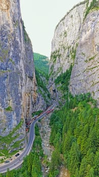 Rocky mountain pass in Romanian Carpathians, highway road near huge rocks