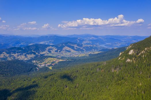 Aerial view of forest village, winter resort in Romanian Carpathians.