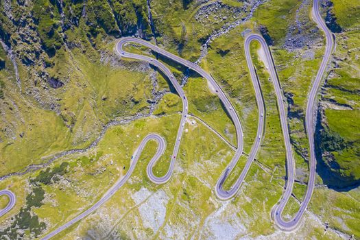Above view of curvy road in Romanian Carpathians, summer view