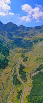 Aerial view in Romanian Carpathians, summer mountain winding road uphill