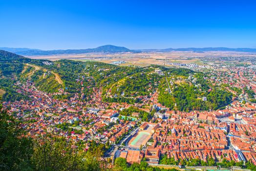 Old city of Brasov viewed from Tampa Hill, summer aerial view in Romania.