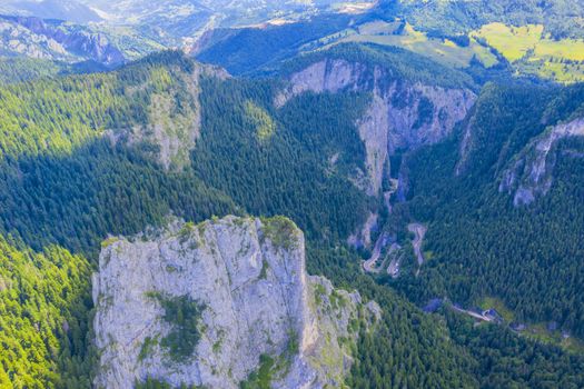 Aerial view of narrow canyon in Romania, Bicaz Gorges and curvy road from above