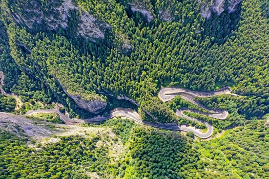 Above view of mountain winding road in green forest, Bicaz Gorges in Romanian Carpathians