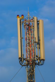 Telecommunication tower, antenna and transmitter with blue sky behind