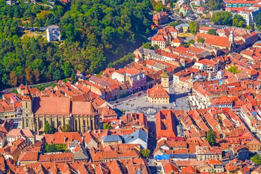 Aerial view of medieval city of Brasov, Romania; Black Church and Council Square, Famous touristic destination in Romania