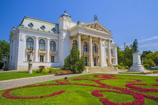 Iasi National Theatre building (19th century) and flower garden in Romania.