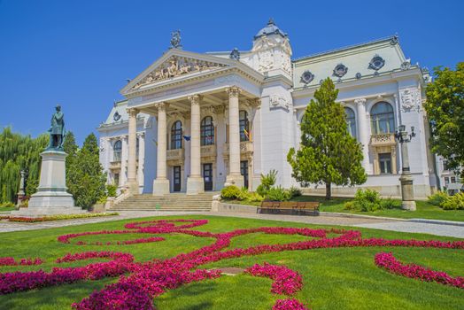 Iasi National Theatre building (19th century) and flower garden in Romania.