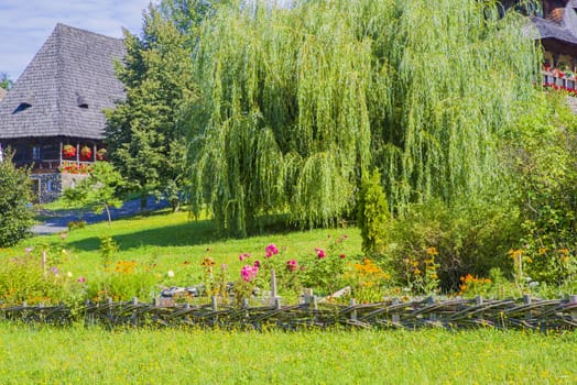 Summer garden scene at Barsana Monastery in Romania